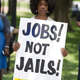A demonstrator at a rally after a protest march calling on President Barack Obama to end the war on drugs, and calling for additional investment in jobs in urban neighborhoods, during a Day of Direct Action event in Lafayette Park in Washington, D.C., on June 17, 2013
SAUL LOEB/AFP/Getty Images